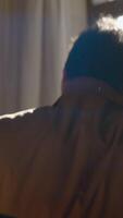 Man in suit waiting on chair. Action. Rear view of man in suit sitting on background of window. Man in suit is sitting in chair and waiting video