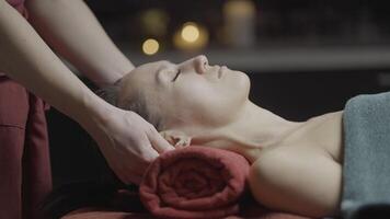 Massage of front part of body. Action. Rejuvenating and relaxing massage at spa. Professional massage of collarbones and face. Spa salon video