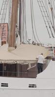 Beautiful moored white large ship. Action. New frigate on a cloudy sky background, concept of holidays and journey. video