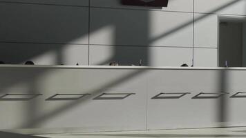Minimalistic interior of a hotel lobby with the reception desk. HDR. Concept of architecture and design, grey reception desk and a wall with a minimum of details. video