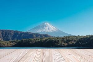 Empty wood table mockup with Mount Fuji view at Saiko lake background and copy space for text, Mock up for your product display and montage. Japan travel and vacation concept photo