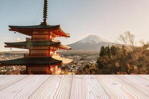 Empty wood table mockup with Mount Fuji view at Chureito Pagoda background and copy space for text, Mock up for your product display and montage in autumn season. Japan travel and vacation concept photo