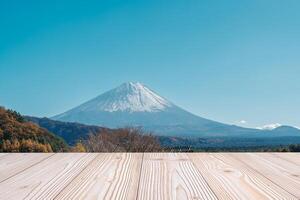Empty wood table mockup with Mount Fuji view at Saiko Iyashino Sato Nenba background and copy space for text, Mock up for your product display and montage in autumn season. Japan travel and vacation photo