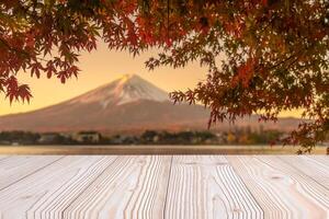 Empty wood table mockup with Mount Fuji view at Kawaguchiko lake background and copy space for text, Mock up for your product display and montage in autumn season. Japan travel and vacation concept photo