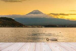 Empty wood table mockup with Mount Fuji view at Kawaguchiko lake background and copy space for text, Mock up for your product display and montage. Japan travel and vacation concept photo