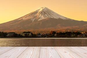 Empty wood table mockup with Mount Fuji view at Kawaguchiko lake background and copy space for text, Mock up for your product display and montage. Japan travel and vacation concept photo