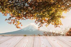 Empty wood table mockup with Mount Fuji view at Kawaguchiko lake background and copy space for text, Mock up for your product display and montage in autumn season. Japan travel and vacation concept photo