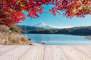 Empty wood table mockup with Mount Fuji view at Saiko lake background and copy space for text, Mock up for your product display and montage in autumn season. Japan travel and vacation concept photo