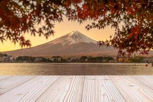 Empty wood table mockup with Mount Fuji view at Kawaguchiko lake background and copy space for text, Mock up for your product display and montage in autumn season. Japan travel and vacation concept photo