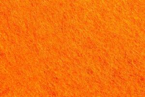 Orange felt texture with copy space, fabric background photo