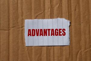 Advantages message written on ripped torn paper with cardboard background. Conceptual advantages symbol. Copy space. photo