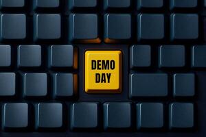 Demo day text written on yellow button on black keyboard. Conceptual demo day symbol. Copy space. photo