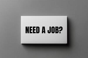 Need a job message written on business card on grey background. Conceptual need a job question symbol. Copy space. photo