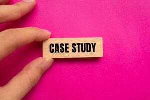 Case study message written on wooden block with pink background. Conceptual case study symbol. Copy space. photo