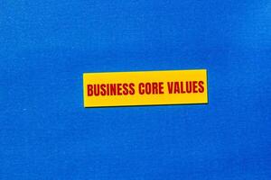 Business core values message written on yellow sticker with blue background. Conceptual business core values symbol. Copy space. photo