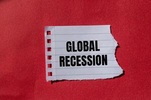 Global recession message written on ripped torn paper with red background. Conceptual global recession symbol. Copy space. photo