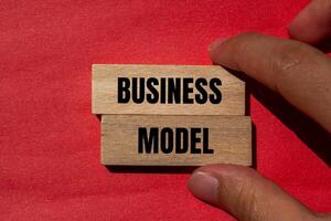 Business model message written on wooden blocks with red background. Conceptual business model symbol. Copy space. photo