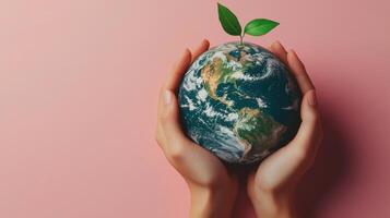 Hands Holding Earth with Growing Plant on Pink Background Symbolizing Environmental Conservation and Global Responsibility photo