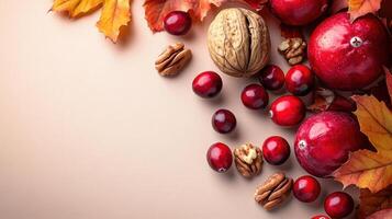 Autumn Harvest Composition with Cranberries, Walnuts, and Fall Leaves on a Beige Background photo