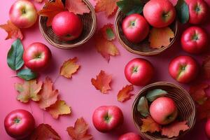 Fresh Red Apples in Baskets with Autumn Leaves on Pink Background - Seasonal Harvest Concept photo