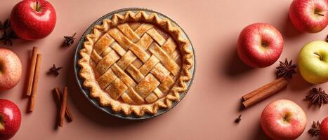 Freshly Baked Apple Pie with Lattice Crust Surrounded by Red and Green Apples, Cinnamon Sticks, and Star Anise on a Brown Background photo