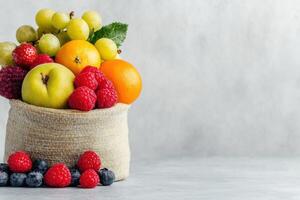 Fresh Fruits in Burlap Sack on Light Background - Healthy Eating, Preservation, and Storage Concept photo
