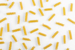 Pasta products in the form of a spiral, texture, on a white background photo