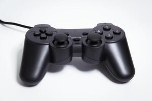 Black controller on white background, game device, Joystick on a white background. photo