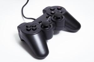 Black controller on white background, game device, Joystick on a white background. photo