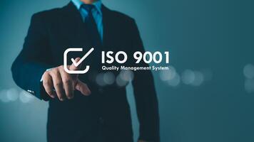 ISO 9001 Standard certification standardisation quality control concept. Businessman point your finger at text ISO 9001 for quality management of organizations, Certified and quality. photo