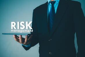 Person use tablet with virtual icon of Risk analysis in business decisions, Risk management concept, Risk control and management strategies for risky businesses. photo