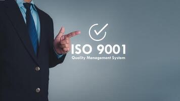 ISO 9001 Standard certification standardisation quality control concept. Businessman point your finger at text ISO 9001 for quality management of organizations, Certified and quality. photo