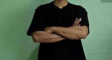 Potrait of pleasant man arms folded look at sale empty space photo
