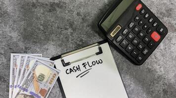 Concept of Cash flow write on paperwork isolated on wooden background. photo