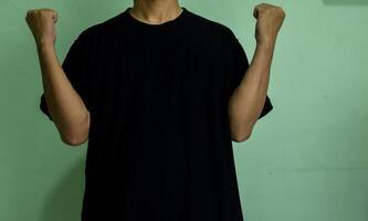 Young confident man pointing to himself isolated on green background photo