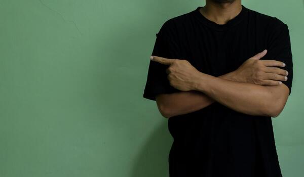 Young man pointing at copy space, showing and advertising empty space photo