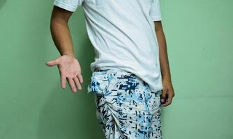 Man white shirt open hand with empty short pants pocket photo