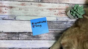 Concept of Easy or Complicated write on sticky notes isolated on Wooden Table. photo