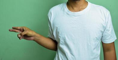 young male's hand being raised while showing deaf alphabet, forming letter H with fingers photo