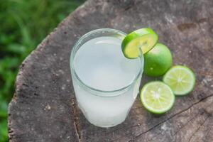 Fresh coconut water from yellow coconuts added with lime juice photo