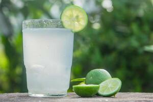 Fresh coconut water from yellow coconuts added with lime juice photo