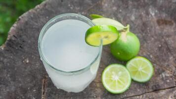 Fresh coconut water from yellow coconuts added with lime juice photo