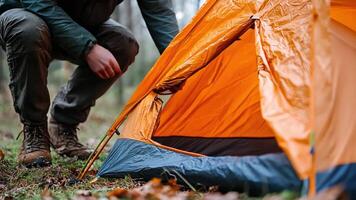 A man is setting up a tent in the woods video