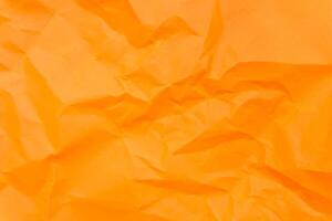 Top view and full frame of wrinkled or crumpled orange paper texture used as crumpled paper background texture in decorative art work photo