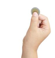 Child or kid hand holding coin isolated on white background with clipping path Concept of saving money for the future or money growth photo