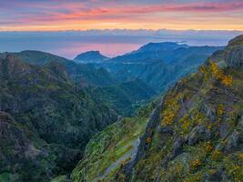 Mountains on sunrise covered in fog and clouds. Madeira island, Portugal photo