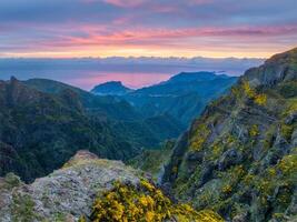 Mountains on sunrise covered in fog and clouds. Madeira island, Portugal photo