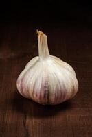 Garlic bulb on wooden background photo