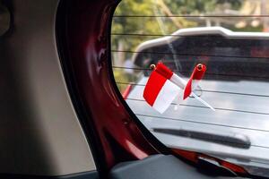 Miniature of Indonesian red and white flag attached to the rear window of a car photo