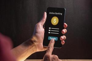A man using a smartphone to access online mobile banking. Concept of money transfer or payment transaction. photo